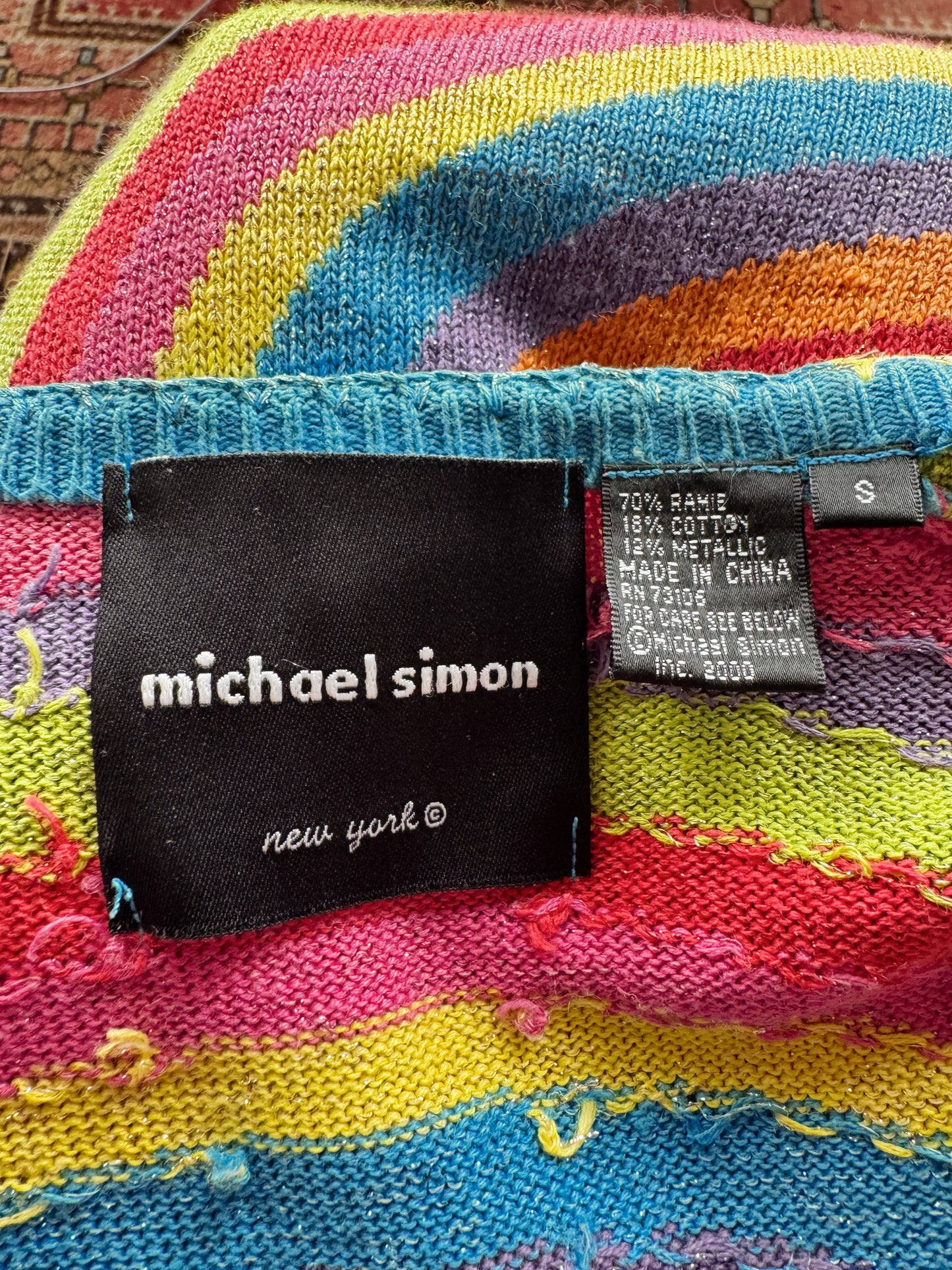Colorful fabric with 'Michael Simon' label on a textured surface