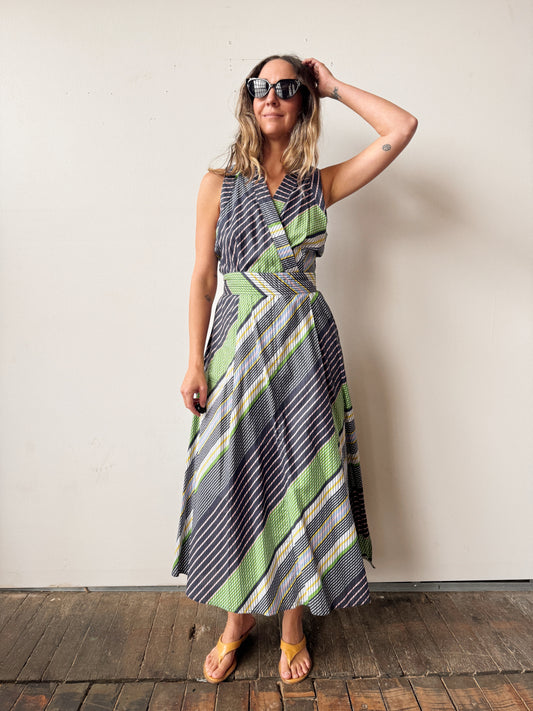 Woman wearing a patterned dress against a plain background